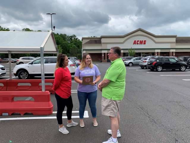 CHC students Lauren Kropp (left) and Kira Altomari surveying citizens at a nearby ACME for their criminal justice class.
