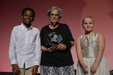 Dr. Conn poses with two young patients after receiving her award.