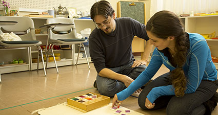 student and teacher working in a classroom